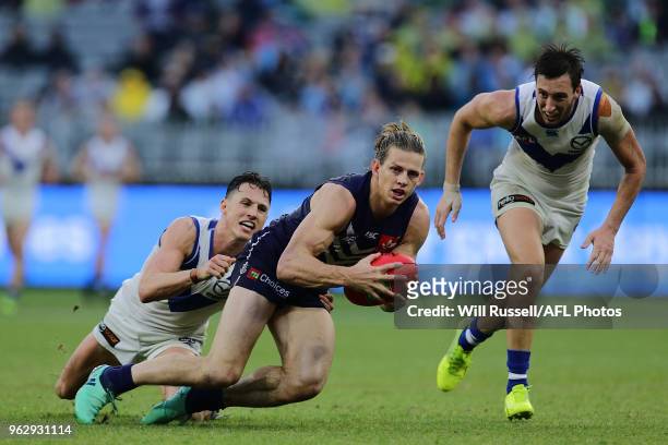 Nat Fyfe of the Dockers is tackled by Ben Jacobs of the Kangaroos during the round 10 AFL match between the Fremantle Dockers and the North Melbourne...