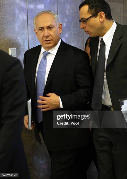 Israeli Prime Minister Benjamin Netanyahu and Cabinet Secretary Zvi Hauser arrive for the weekly cabinet meeting in his Jerusalem offices on January...