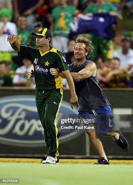 Pitch invader tackles Khalid Latif of Pakistan during the fifth One Day International match between Australia and Pakistan at WACA on January 31,...