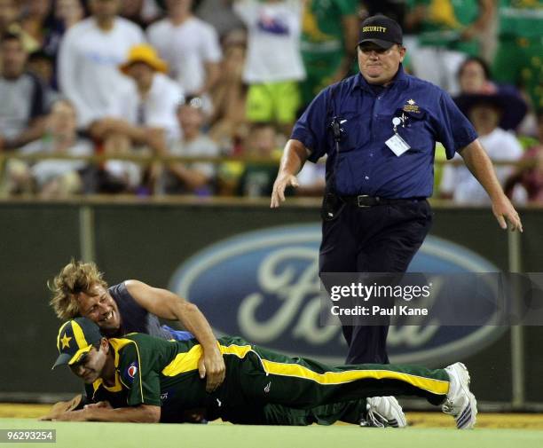 Pitch invader tackles Khalid Latif of Pakistan during the fifth One Day International match between Australia and Pakistan at WACA on January 31,...