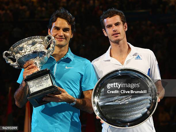 Roger Federer of Switzerland and Andy Murray of Great Britain pose with their trophies after the men's final match during day fourteen of the 2010...