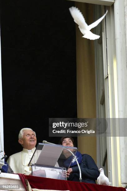 Pope Benedict XVI and two children of the Italian Association 'Azione Cattolica' free two doves as a symbol of peace at the end of his Sunday angelus...