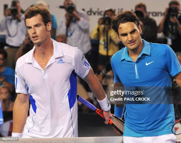 Roger Federer of Switzerland walks off the court with Andy Murray of Britain following his victory in their men's singles final on day 14 of the...