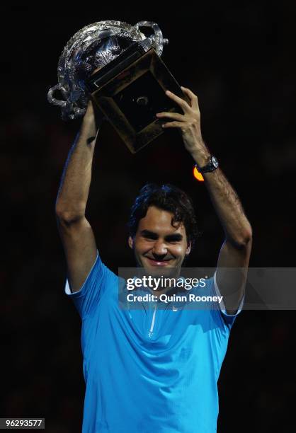 Roger Federer of Switzerland holds aloft the Norman Brookes Challenge Cup after his men's final match against Andy Murray of Great Britain during day...