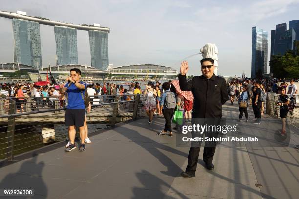 Kim Jong Un impersonator, Howard X waves as he walks along the Jubilee Bridge at Marina Bay on May 27, 2018 in Singapore. The proposed North...