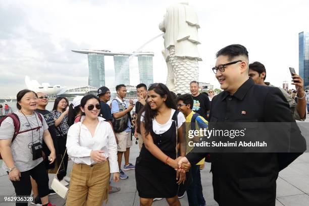 Kim Jong Un impersonator, Howard X greets tourists as he makes an appearance at Merlion Park on May 27, 2018 in Singapore. The proposed North...