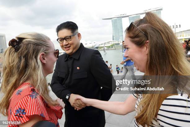 Kim Jong Un impersonator, Howard X greets tourists as he makes an appearance at Merlion Park on May 27, 2018 in Singapore. The proposed North...