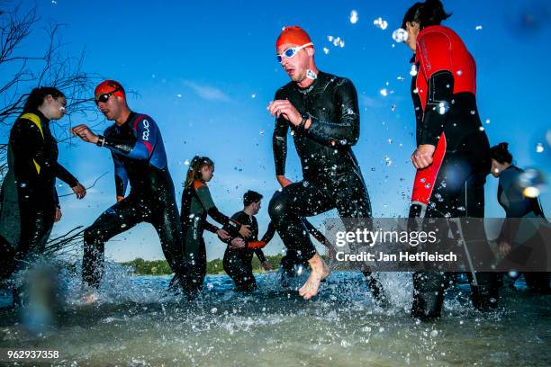 Participants compete in the swim leg of the race during IRONMAN 70.3 St Polten on May 27, 2018 in Sankt Polten, Austria.