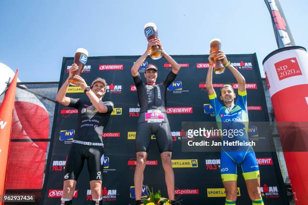 Ruedi Wild of Switzerland, Michael Weiss of Austria and Giulio Molinari of Italy pose for a picture during the flower ceremony of the IRONMAN 70.3 St...
