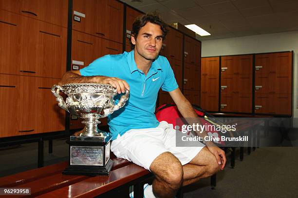 Roger Federer of Switzerland poses with the Norman Brookes Challenge Cup in the players locker room after winning the men's final match against Andy...