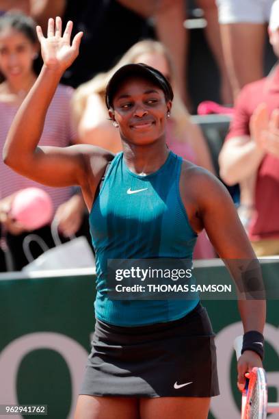 Sloane Stephens of the US waves as she celebrates after victory over Netherlands' Arantxa Rus in their women's singles first round match on day one...