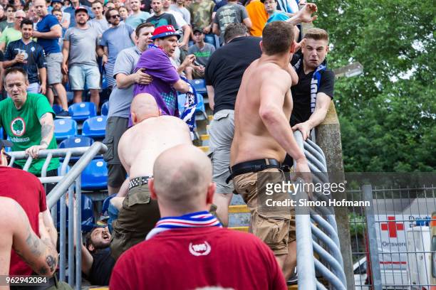 Supporters of both teams fight during the Third League Playoff Leg 2 match between SV Waldhof Mannheim and KFC Uerdingen at Carl-Benz-Stadium on May...