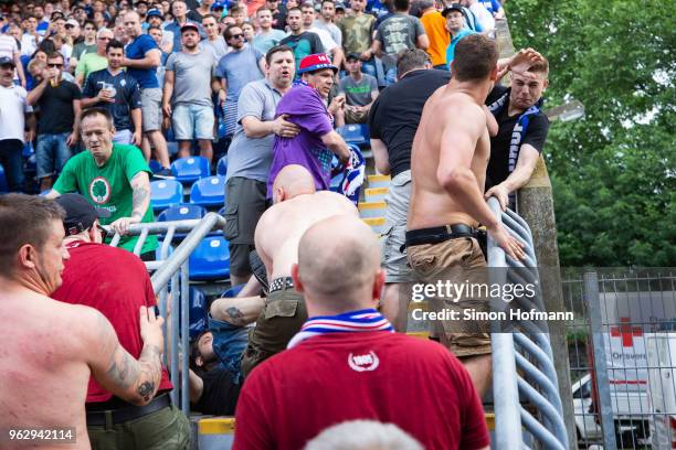 Supporters of both teams fight during the Third League Playoff Leg 2 match between SV Waldhof Mannheim and KFC Uerdingen at Carl-Benz-Stadium on May...