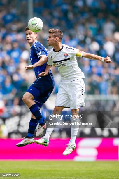 Mario Erb of Uerdingen jumps for a header with Gian-Luca Korte of Mannheim during the Third League Playoff Leg 2 match between SV Waldhof Mannheim...