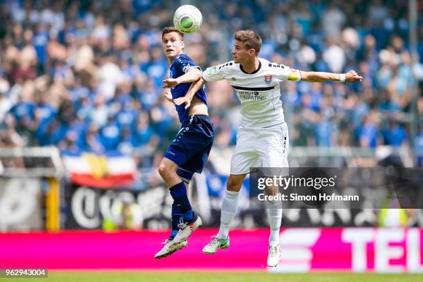 Mario Erb of Uerdingen jumps for a header with Gian-Luca Korte of Mannheim during the Third League Playoff Leg 2 match between SV Waldhof Mannheim...
