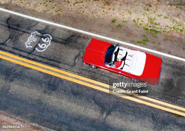 drone view of red car driving famous road. - route 66 stock pictures, royalty-free photos & images