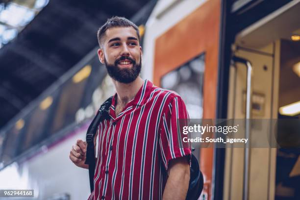 man getting off the train - train leaving stock pictures, royalty-free photos & images