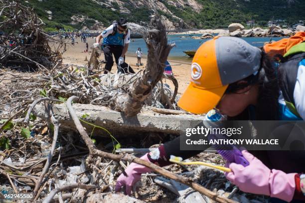 Participants take part in a beach clean-up on Hong Kong's outlying Lamma island on May 27, 2018. - More than two thousand volunteers hit the beach on...