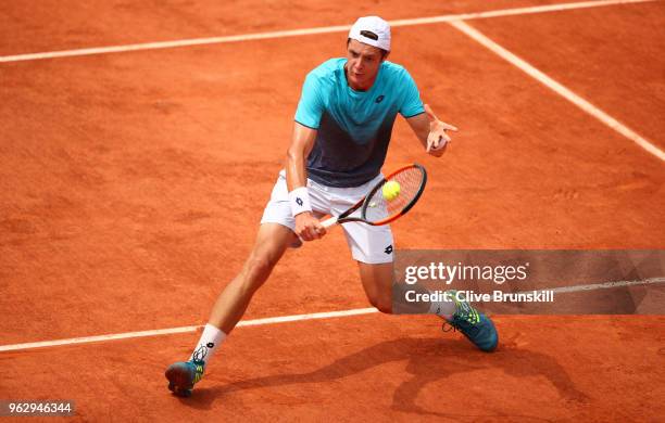 Maxime Janvier of France plays a backhand volley against Kei Nishikori of Japan in their first round mens singles match on day one of the French Open...