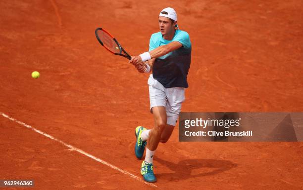 Maxime Janvier of France plays a backhand against Kei Nishikori of Japan in their first round mens singles match on day one of the French Open at...