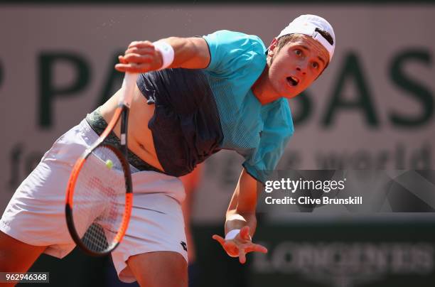 Maxime Janvier of France serves against Kei Nishikori of Japan in their first round mens singles match on day one of the French Open at Roland Garros...