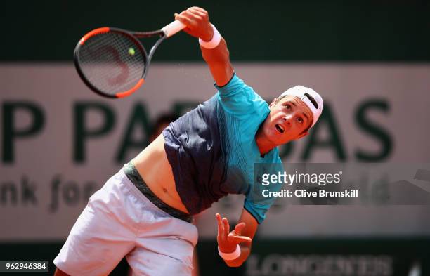 Maxime Janvier of France serves against Kei Nishikori of Japan in their first round mens singles match on day one of the French Open at Roland Garros...