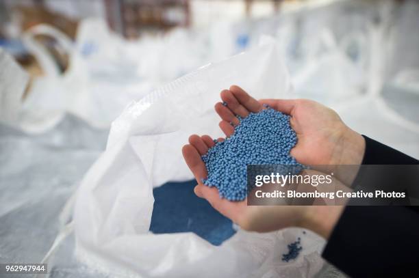 recycled plastic pellets used in the making of plastic bottles - granulat stock-fotos und bilder