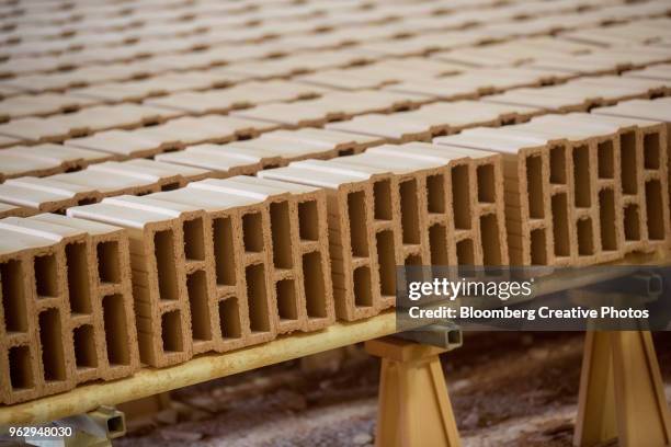 fired clay bricks sit on a kiln car at a brickmaking plant - kiln stock pictures, royalty-free photos & images