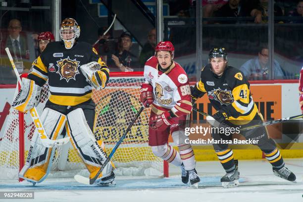 Kaden Fulcher defends the net as Benjamin Gleason of Hamilton Bulldogs back checks German Rubtsov of Acadie-Bathurst Titan at Brandt Centre - Evraz...