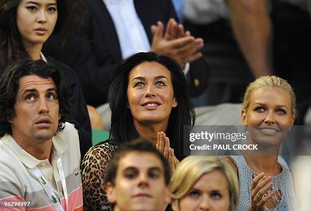 Australian models Megan Gale and Lara Bingle look up at the start of the men's singles final match between Roger Federer of Switzerland and Andy...