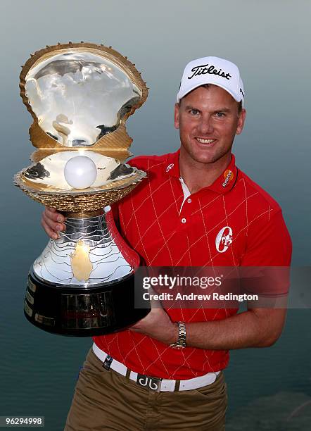 Robert Karlsson of Sweden poses with the trophy after winning the Commercialbank Qatar Masters at Doha Golf Club on January 31, 2010 in Doha,Qatar.