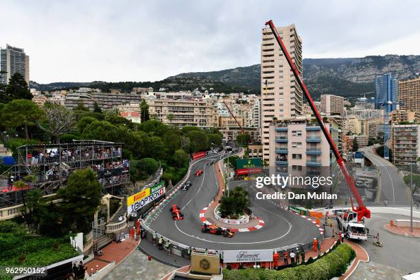 Daniel Ricciardo of Australia driving the Aston Martin Red Bull Racing RB14 TAG Heuer leads Sebastian Vettel of Germany driving the Scuderia Ferrari...