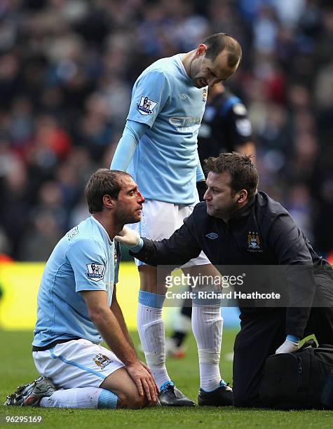 Pablo Zabaleta of Manchester City receives treatment as blood streams from a wound during the Barclays Premier League match between Manchester City...