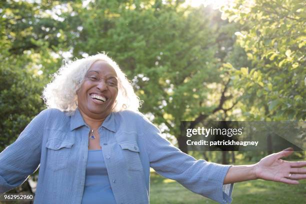 senior woman outside laughing - undershirt stock pictures, royalty-free photos & images