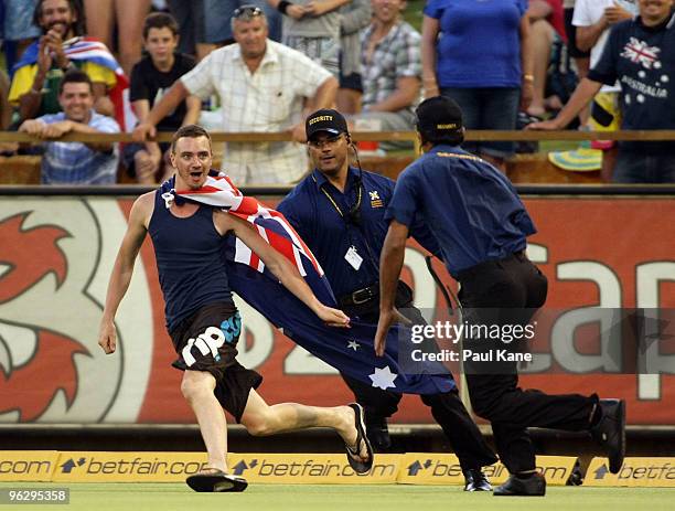 Pitch invader is chased by security during the fifth One Day International match between Australia and Pakistan at WACA on January 31, 2010 in Perth,...