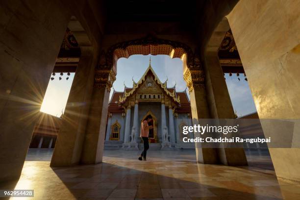 tourists walking in the morning at wat benchamabophit in bangkok, thailand - wat benchamabophit stock pictures, royalty-free photos & images