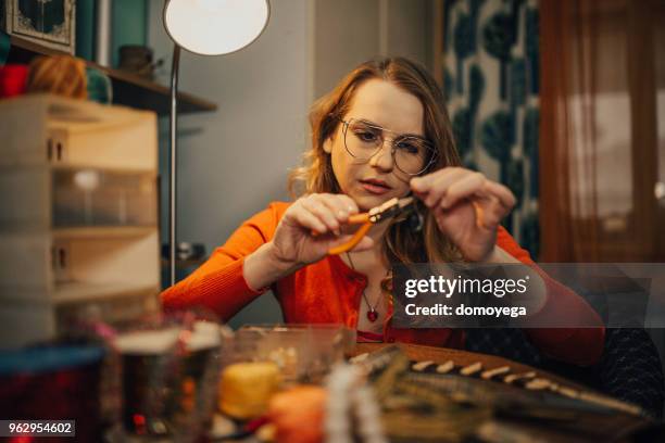 woman making jewelry pieces in the workshop - jewellery making stock pictures, royalty-free photos & images