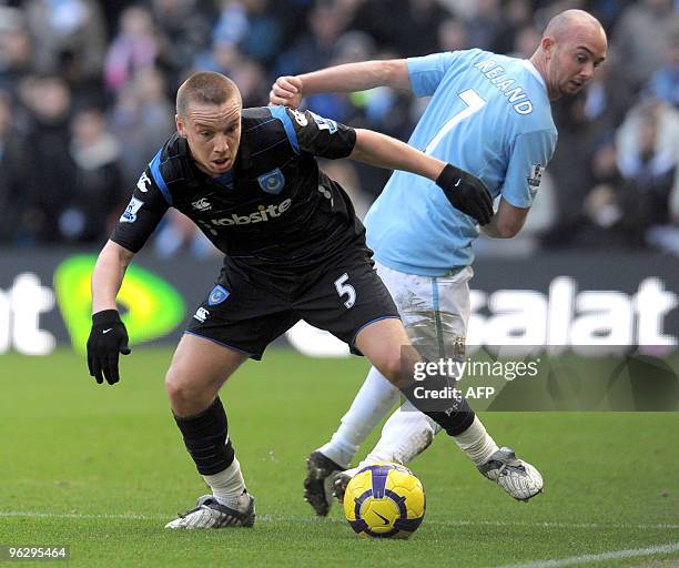 Manchester City's Irish midfielder Stephen Ireland fights for the ball with Portsmouth's English midfielder Jamie O'Hara during their English Premier...