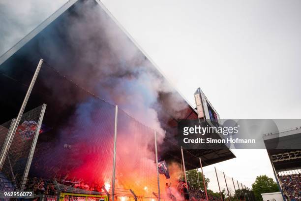 Supporters of Uerdingen light fireworks during the Third League Playoff Leg 2 match between SV Waldhof Mannheim and KFC Uerdingen at...