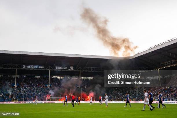 Both teams leave the pitch as the match is interrupted during the Third League Playoff Leg 2 match between SV Waldhof Mannheim and KFC Uerdingen at...