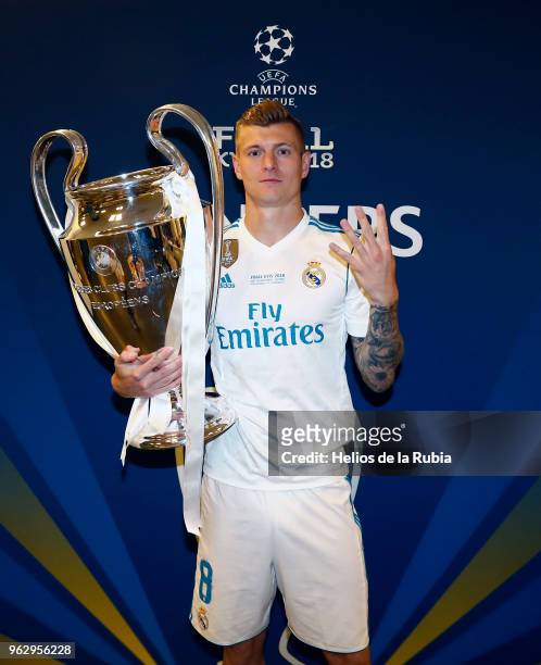 Toni Kroos of Real Madrid poses with the Champions League trophy after the UEFA Champions League Finall match between Real Madrid and Liverpool at...