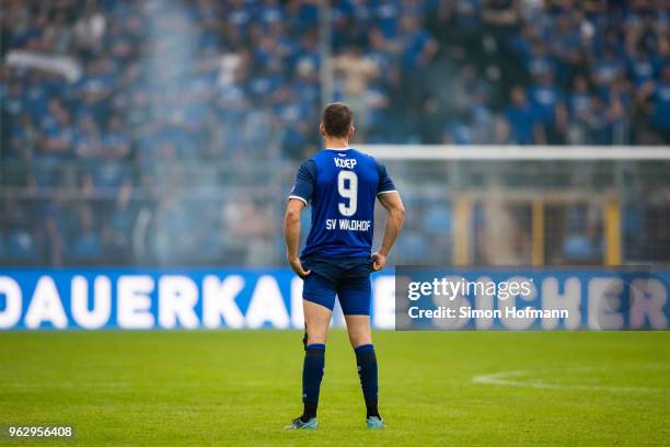 Benedikt Koep of Mannheimreacts as supporters of his team light fireworks during the Third League Playoff Leg 2 match between SV Waldhof Mannheim and...