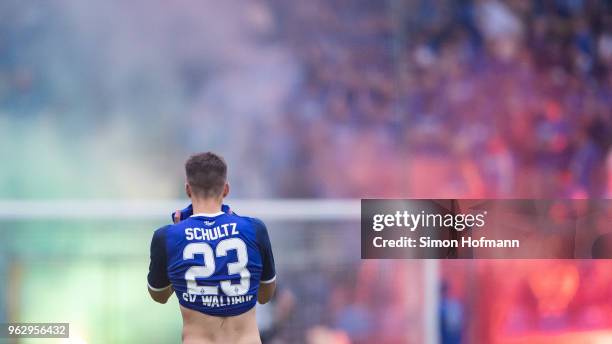 Michael Schultz of Mannheimreacts as supporters of his team light fireworks during the Third League Playoff Leg 2 match between SV Waldhof Mannheim...