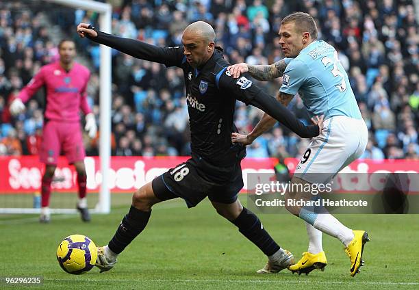 Craig Bellamy of Manchester City challenges Anthony Vanden Borre of Portsmouth during the Barclays Premier League match between Manchester City and...
