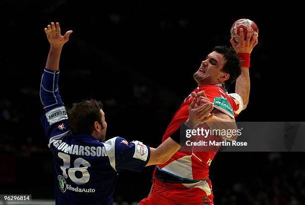 Robert Gunnarsson of Iceland in action with Michal Jurecki of Poland during the Men's Handball European place 3 match between Iceland and Poland at...