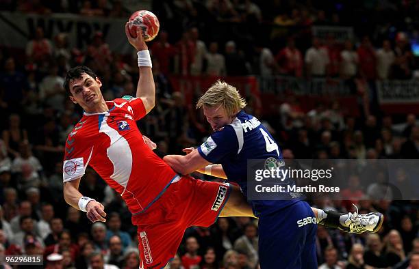 Aron Palmarsson of Iceland blocks Krysztof Lijewski of Poland during the Men's Handball European place 3 match between Iceland and Poland at the...