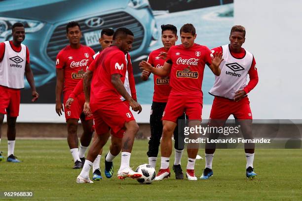 Jefferson Farfan, Aldo Corzo and Pedro Aquino play with the ball during a training session ahead of FIFA World Cup Russia 2018 on May 25, 2018 in...