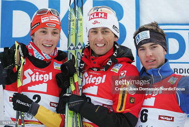 Eric Frenzel of Germany , Mario Stecher of Austria and Alessandro Pittin of Italy celebrate on the podium after the Gundersen Ski Jumping HS 100/10km...