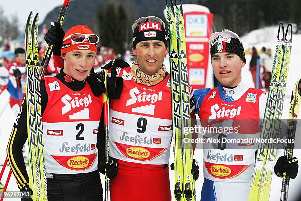 Eric Frenzel of Germany , Mario Stecher of Austria and Alessandro Pittin of Italy celebrate after the Gundersen Ski Jumping HS 100/10km Cross Country...