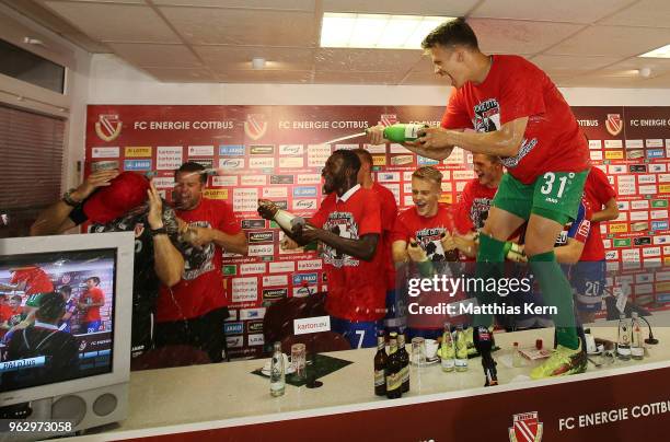 Head coach Claus Dieter Wollitz of Cottbus gets an beer and champagner shower after moving up into the third league after the Third League Playoff...